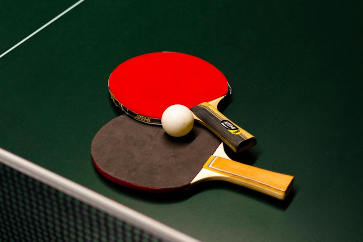 Table tennis ball and rackets on a table