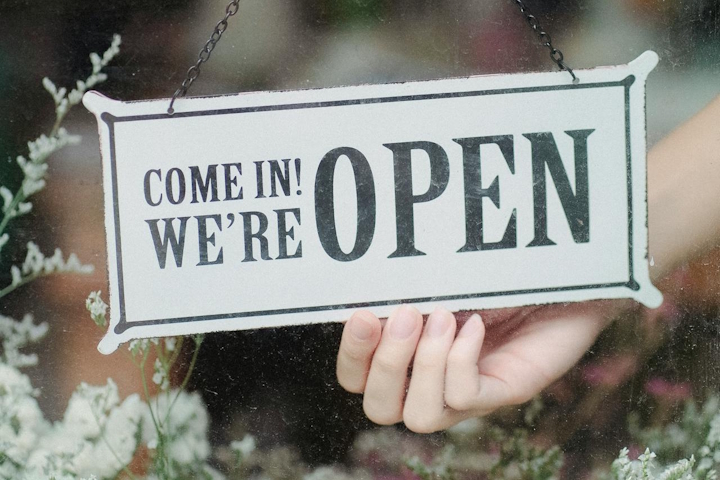 Door sign saying “Come in! We’re open”