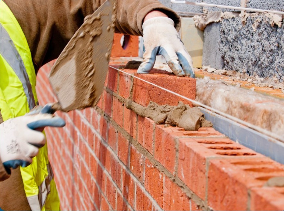 A builder laying bricks