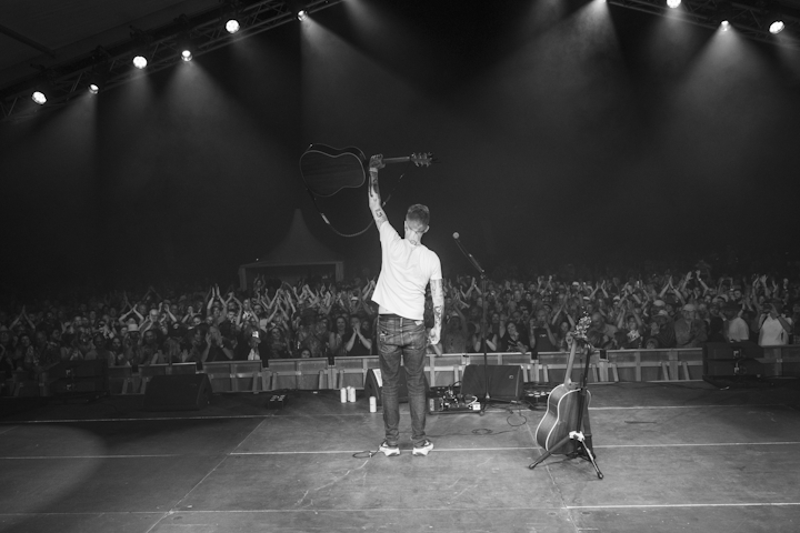 Guitarist on stage at Cambridge Folk Festival 2026