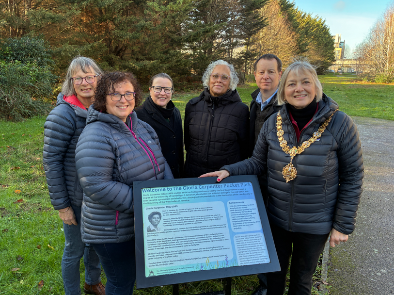 A group of people in front of an information board at Gloria Carpenter Pocket Park in Cambridgea