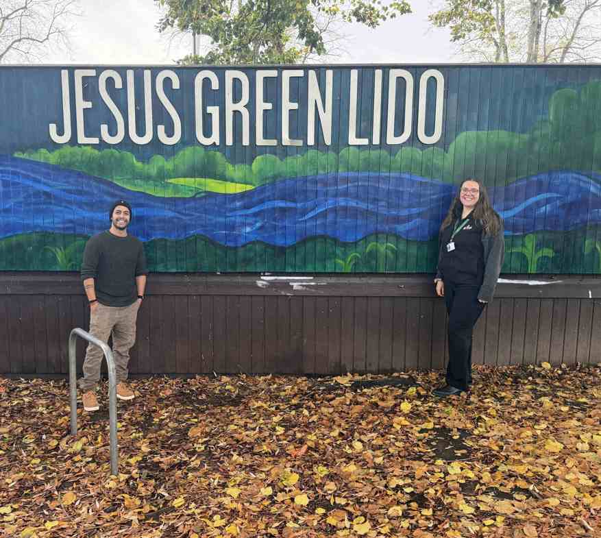 Pictured with the new mural at Jesus Green Lido is artist Anugrah Mishra and GLL assistant manager, Annabel Wright.